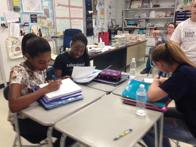 Freshmen Ashlie Pitt, Victoria Varlack, and Kate Gaynor work diligently in Mrs. Lanzas English class.