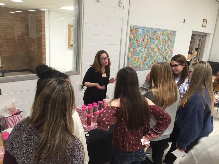 Mrs. Rattien talking to potential customers about her Pink Zebra candles